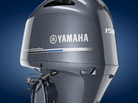 A close-up of a Yamaha 150 outboard boat engine against a blue background.