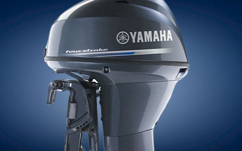 A gray Yamaha outboard boat engine with the &ldquo;Forward&rdquo; branding and Follow the Leader slogan against a blue sky.