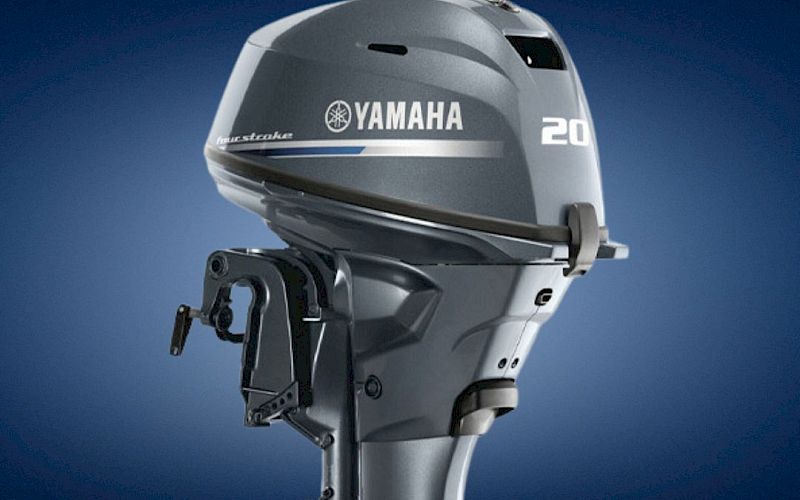 A Yamaha 20 outboard boat engine with the &ldquo;YAMAHA&rdquo; logo against a blue background.