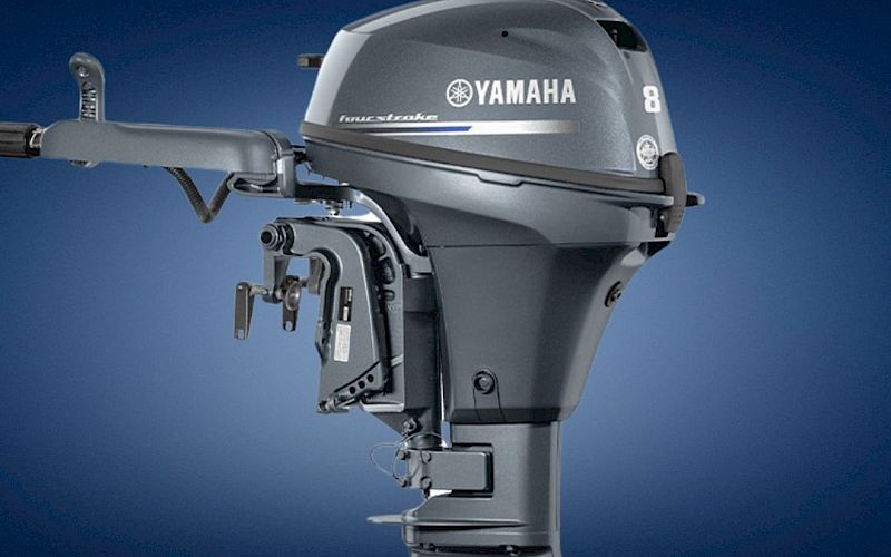 A close-up of a Yamaha outboard boat engine with a propeller housing and &ldquo;YAMAHA&rdquo; branding, against a blue background.