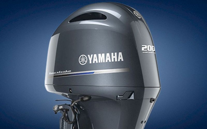 A Yamaha outboard boat motor, showing the &ldquo;200&rdquo; model mark on the cowling against a dark blue background.