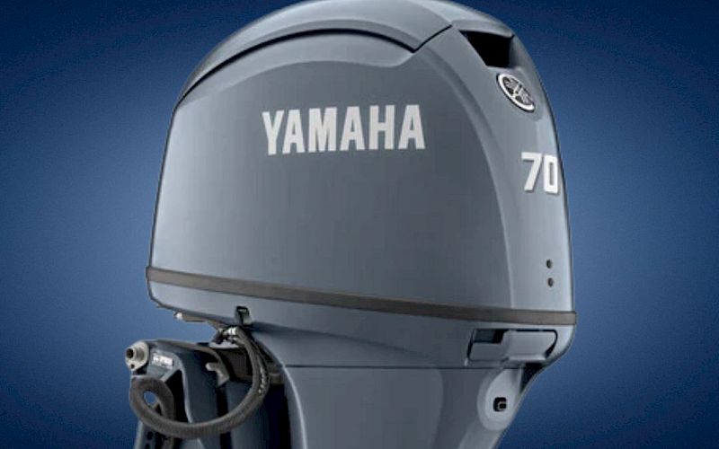 A silver Yamaha outboard boat motor labeled 70 is shown against a blue sky background.