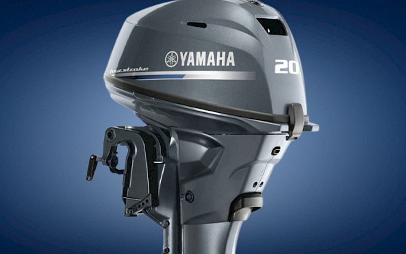 A grey Yamaha 20-hp outboard boat motor against a blue background, shown from a front three-quarter angle.