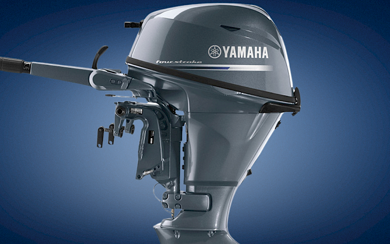 A silver Yamaha outboard boat motor with a propeller, pictured against a blue background.