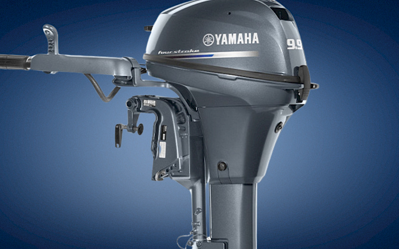 A Yamaha 9.9 outboard boat motor with silver-gray casing is shown against a blue background.